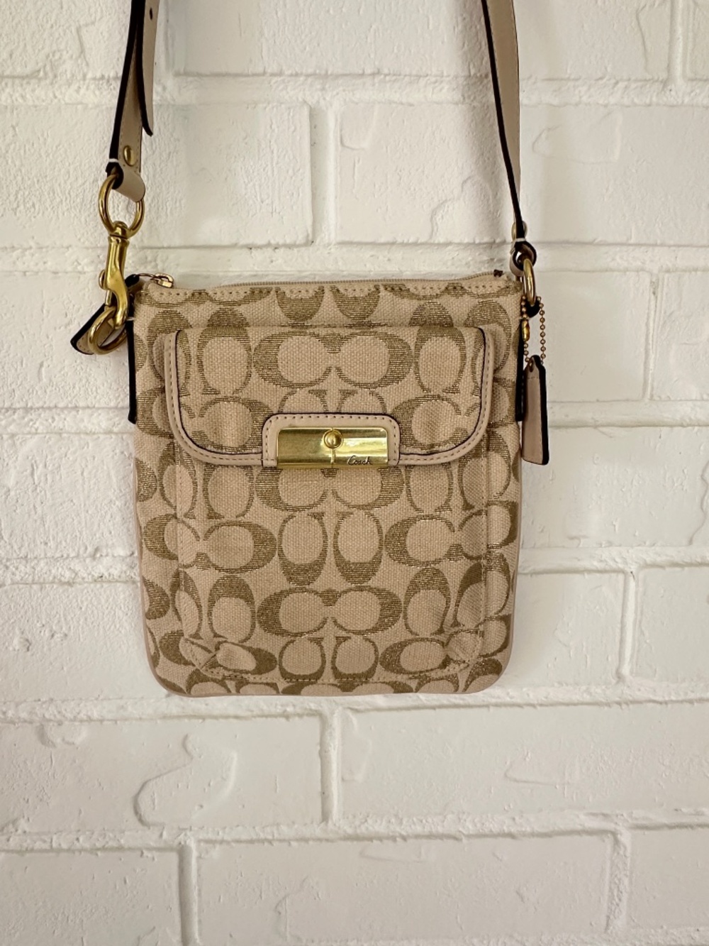 Coach Kristin Signature Crossbody Swing Bag in a metallic gold and beige fabric